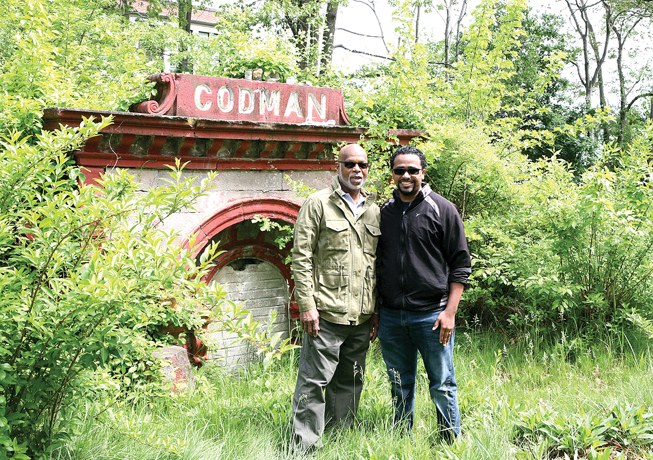 Rev. Victor Price and DuNaiss Pires, of Second Church, in front of the Codman Vault – where Rev. Dr. John Codman is buried. The current project will include some community efforts to clean up the undergrowth in the cemetery portion as well