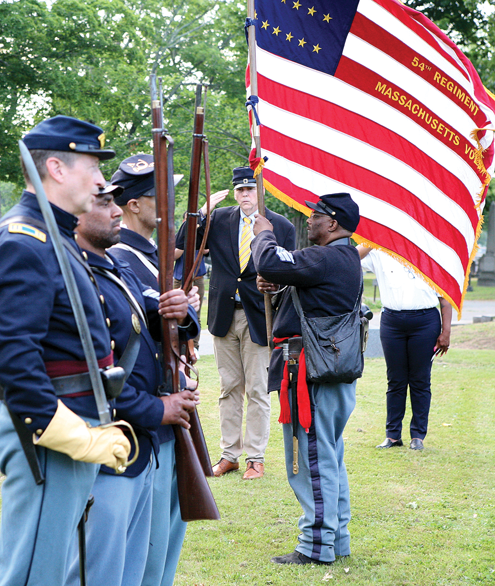 Re-enactors from the 54th Regiment fired three volleys in memory of the soldiers who fought in the Civil War and are buried at Mt. Hope Cemetery