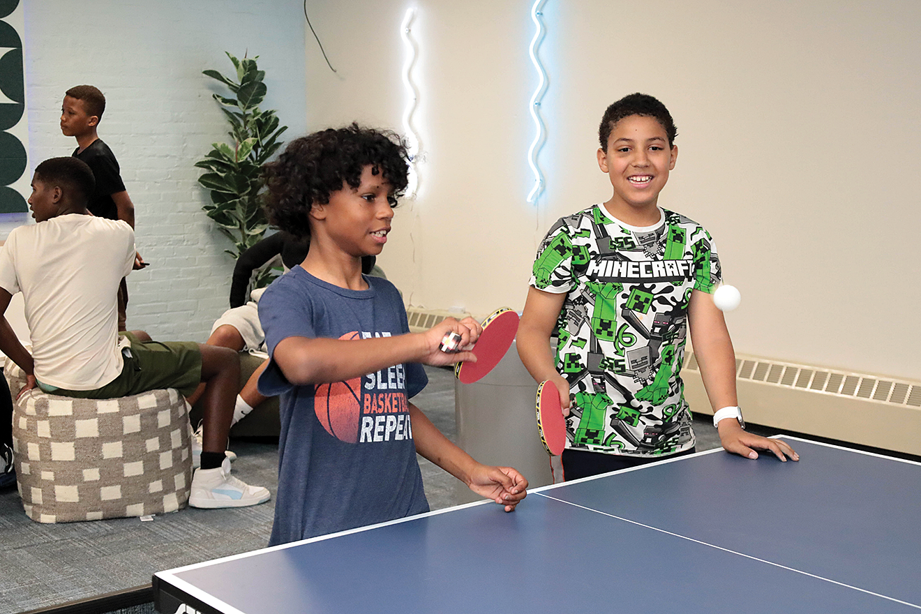 Some of the participants at St. Peter’s Teen Center playing ping pong in the new games room. Olive Encarnación Bernabé photo