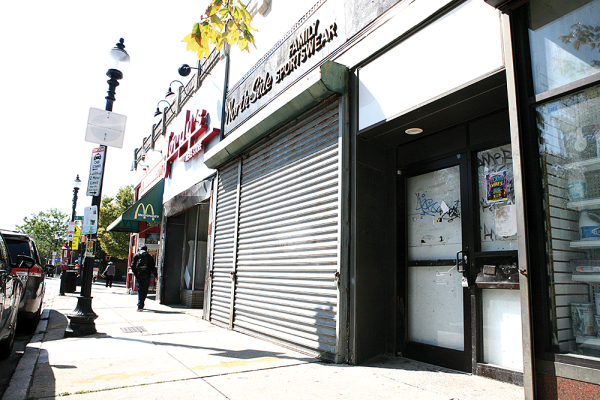 The former Jordy’s Men’s Store closed recently after 65 years in the Square, and North Side Family Sportswear closed 18 months ago. The two long-time retailers retired their businesses and left unoccupied spaces. An ATM once occupied a small space in the bank of stores. Seth Daniel photos